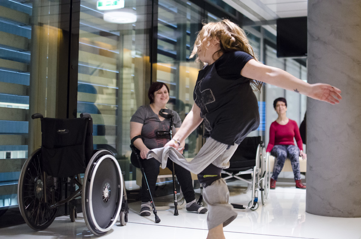 A crip dancer is seen profile dancing with joy