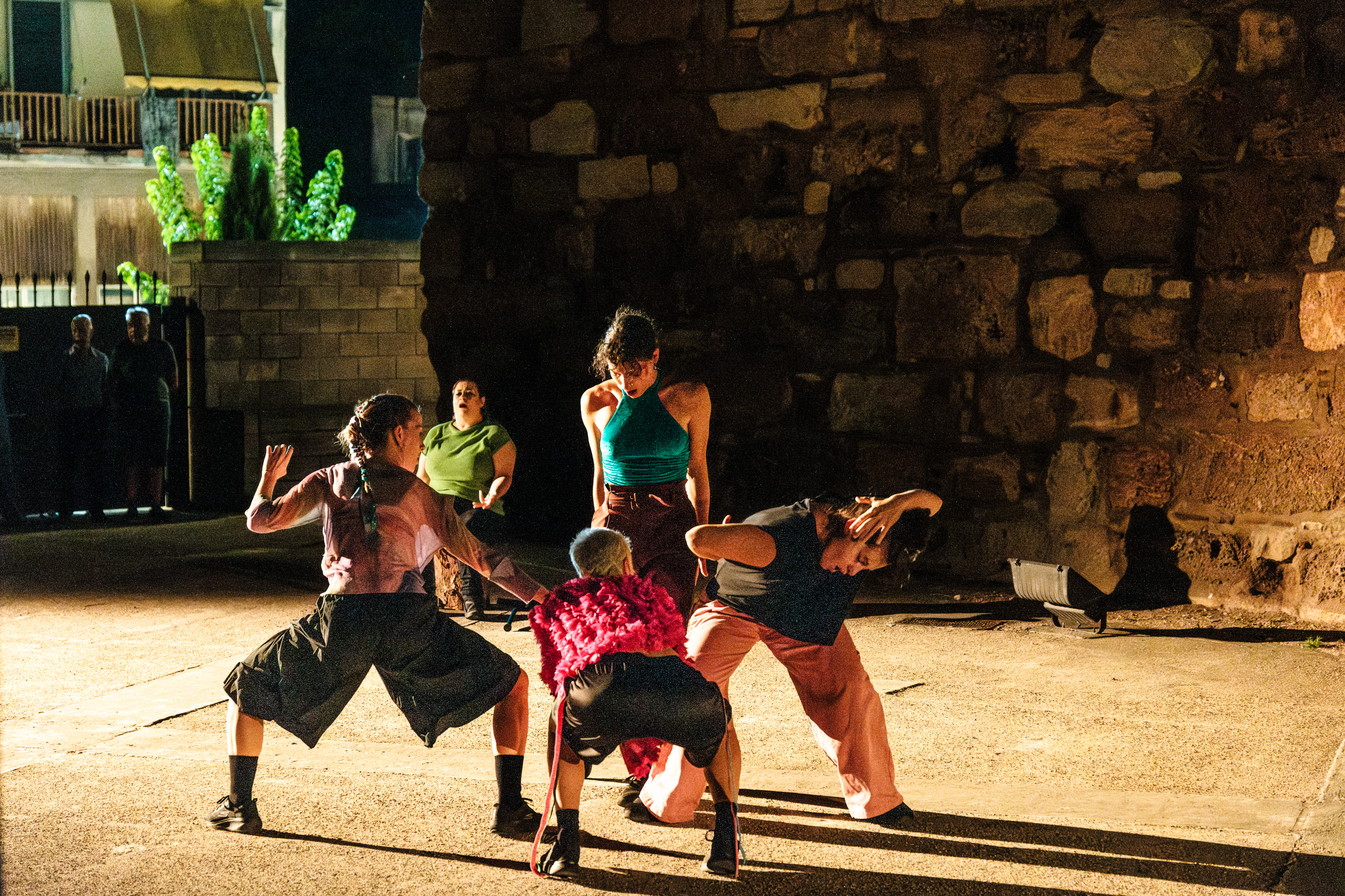 four women form a core on a diagonal that a fifth woman is leading seated