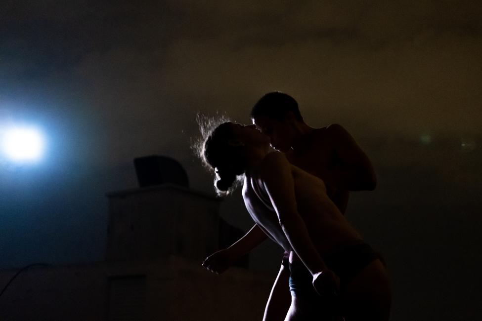 two women face each other at a close distance