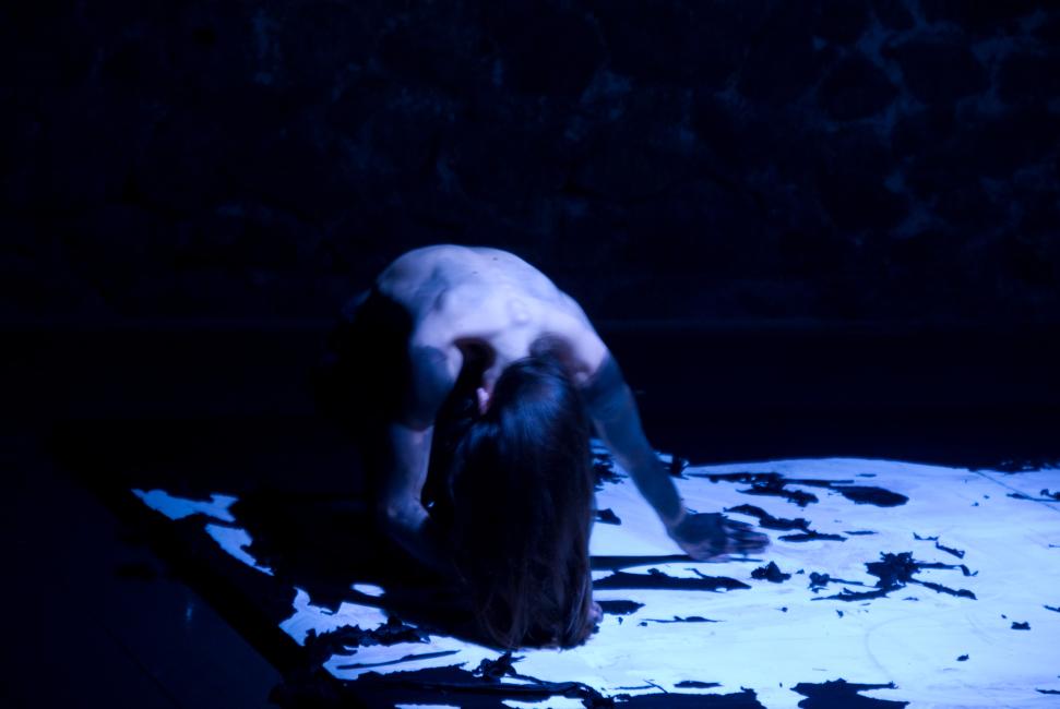 a woman is coming up from the black and white floor marked by the black landscaped settting